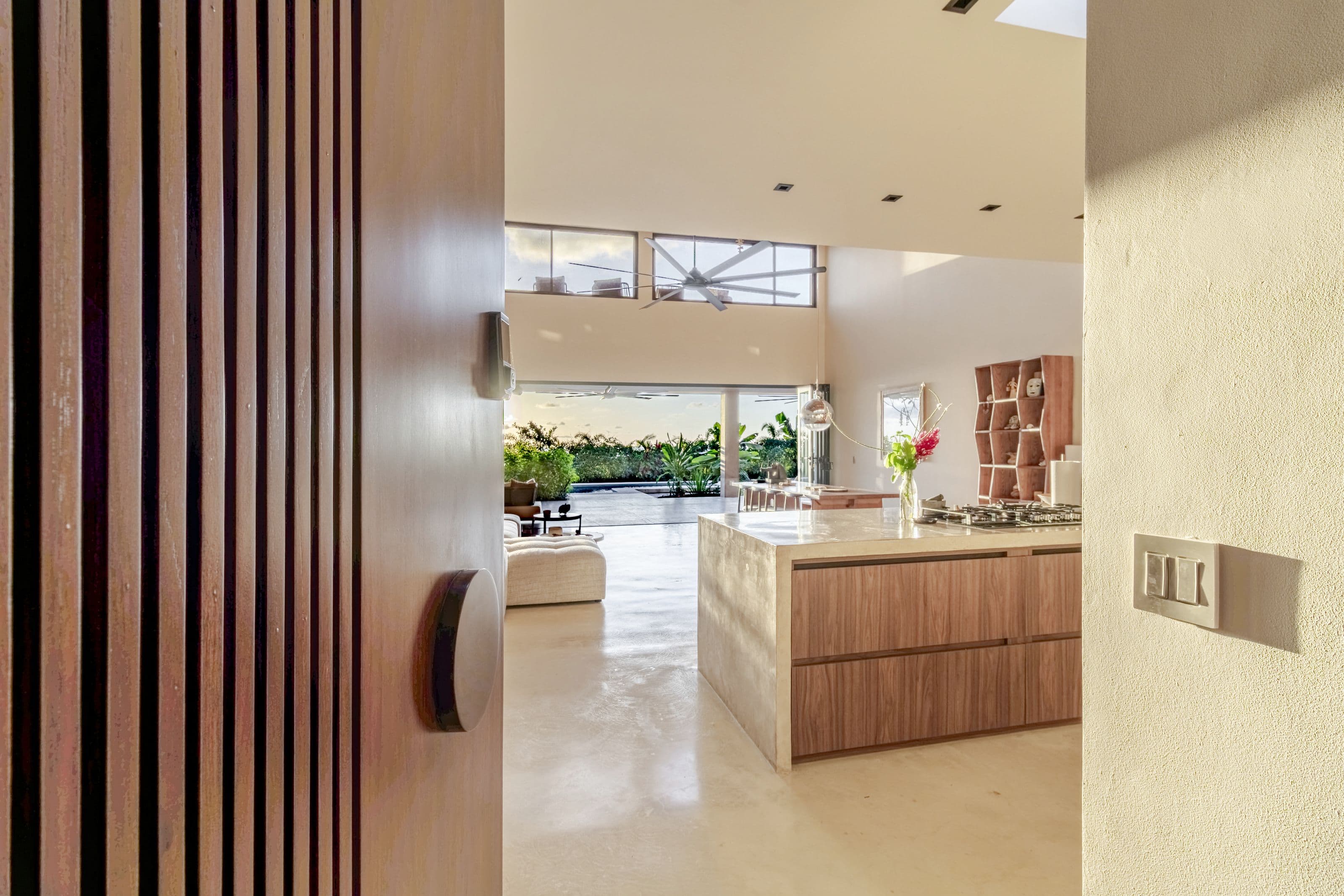 Front door opening onto the kitchen, living area and garden beyond