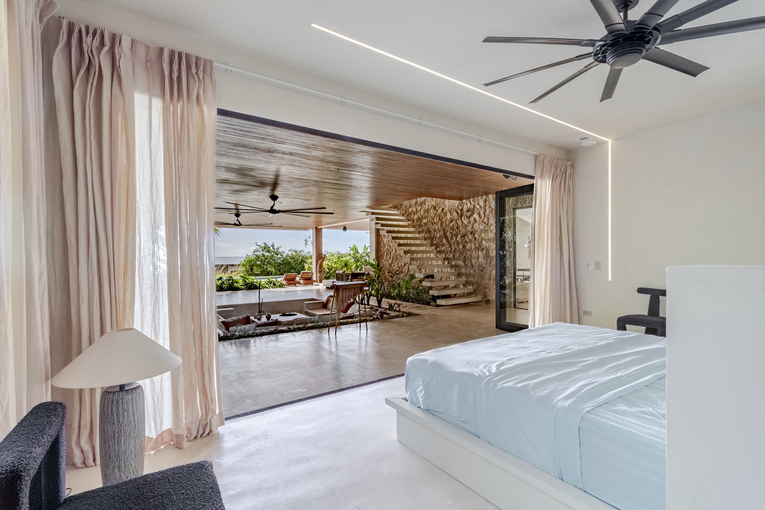 King bedroom opening directly onto the covered terrace and sunken lounge