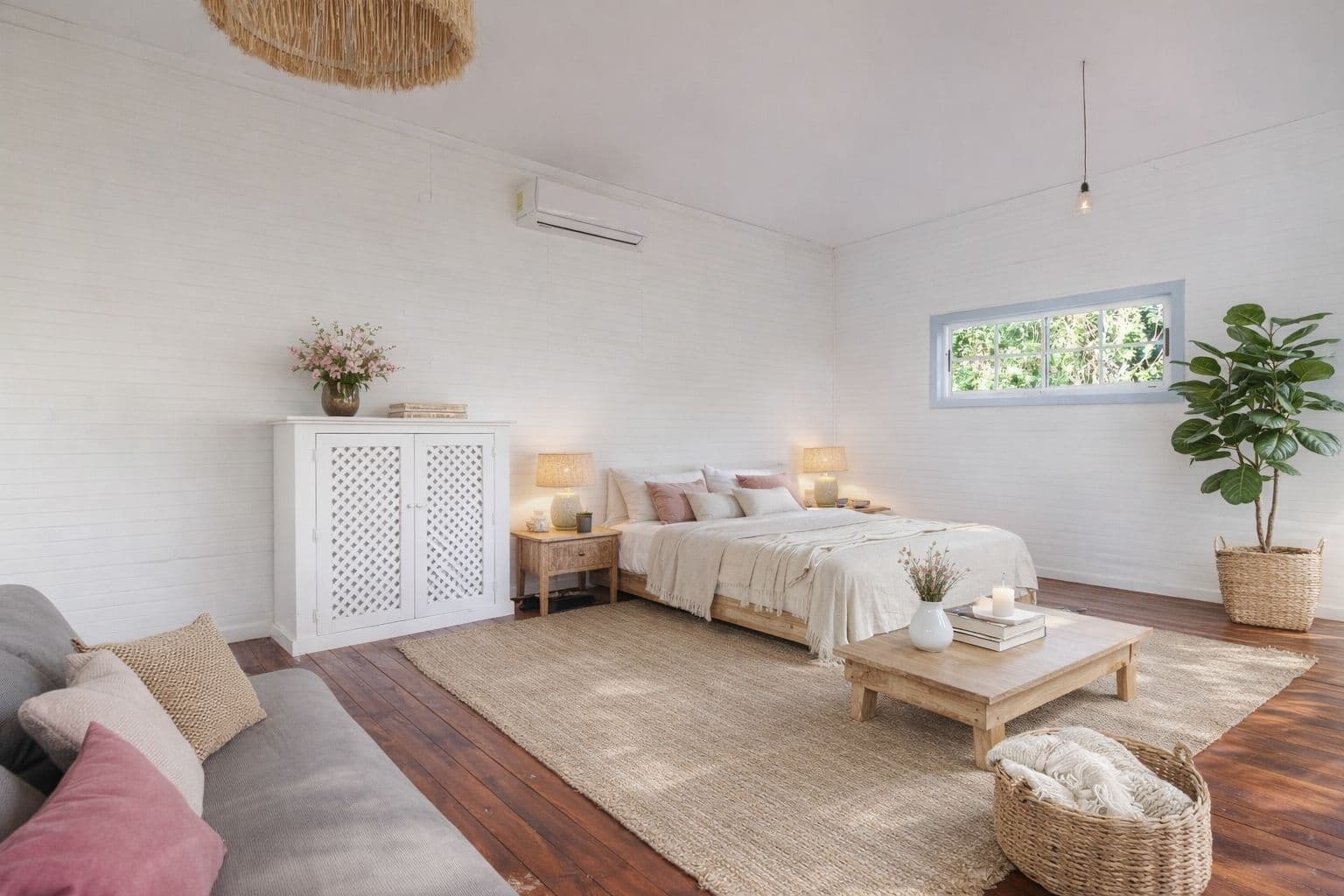 Inside the Surf Shack: the sleeping and living area, with a queen bed and a sofa