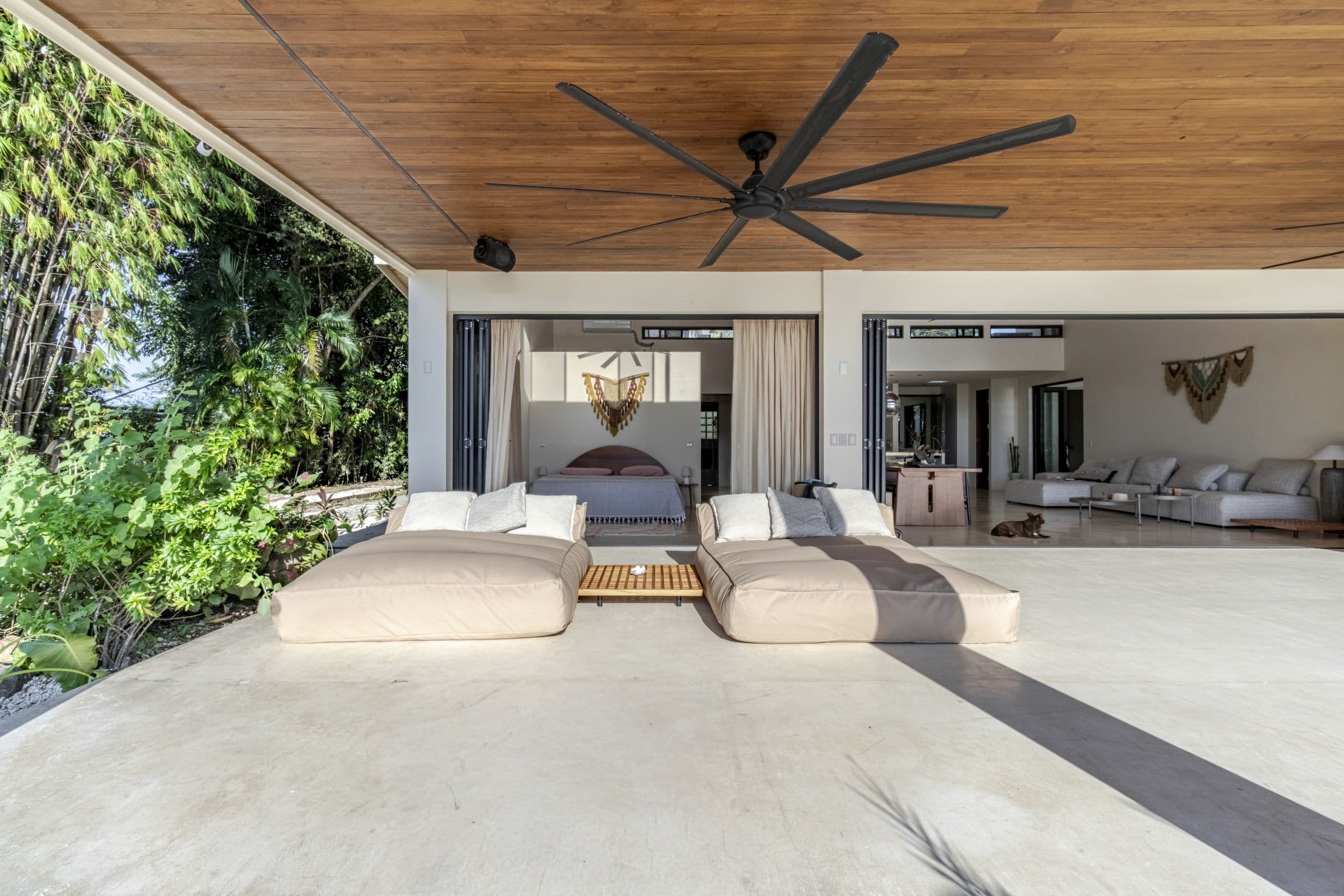 Oversized daybeds on the terrace facing the open-plan living spaces