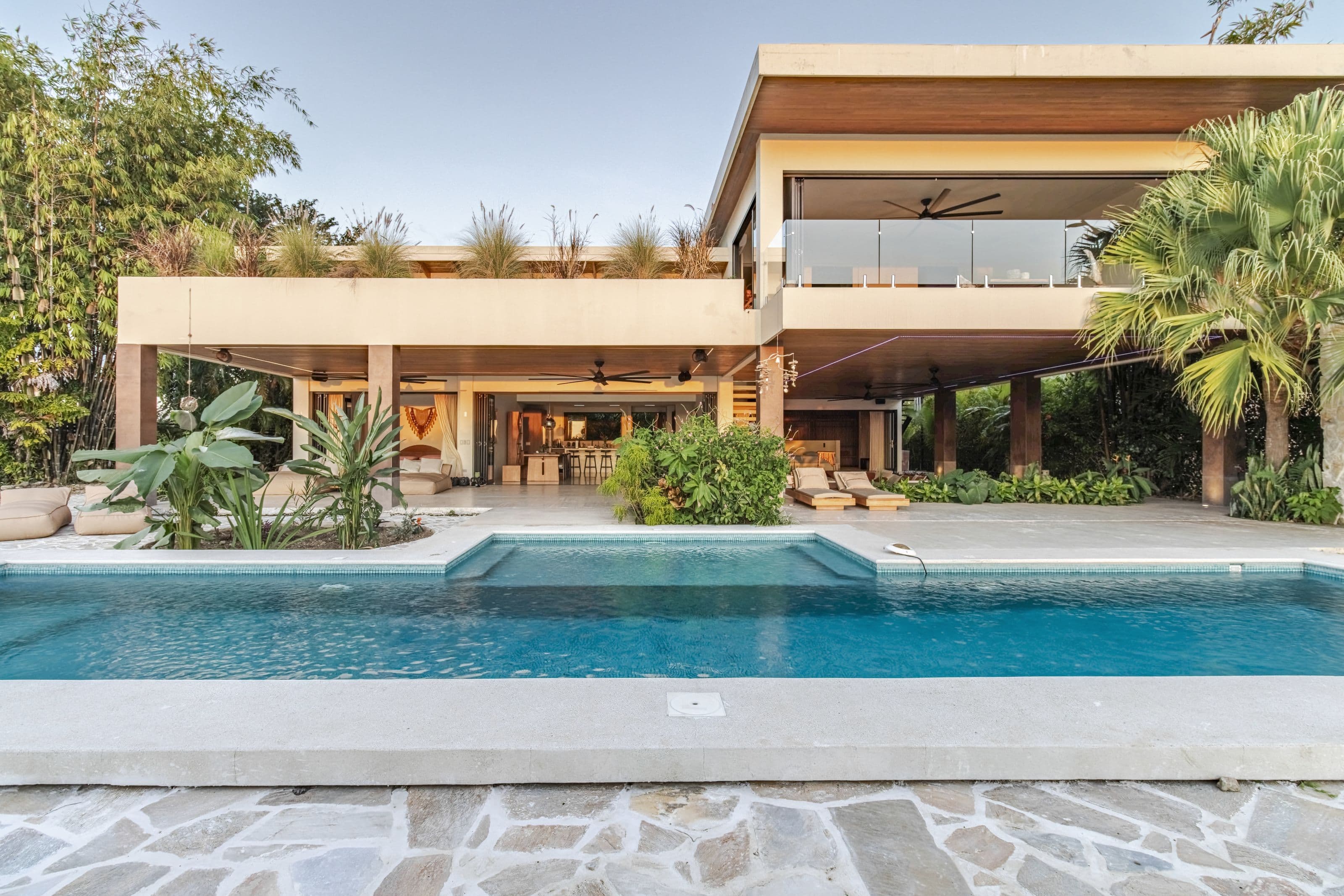 Villa Raya’s modern two-story villa and swimming pool in late-afternoon light, Santa Teresa, Costa Rica
